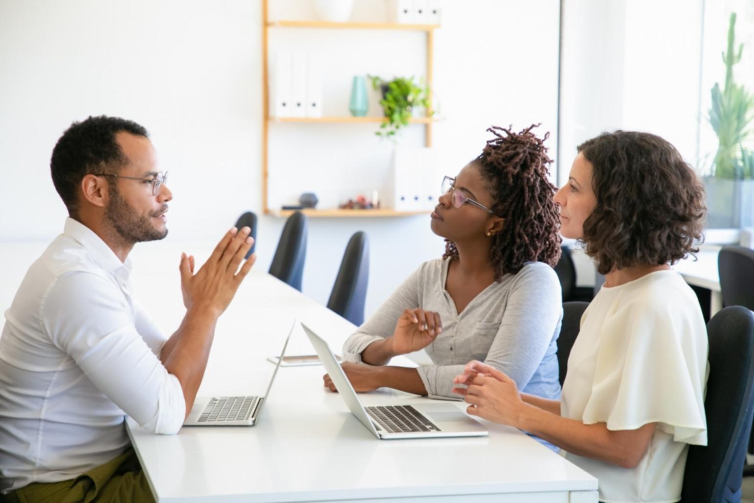 Software testing coordination meeting with stakeholders reviewing acceptance criteria